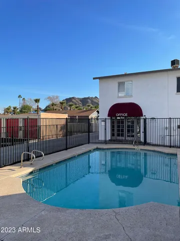 a view of a brick house with large trees