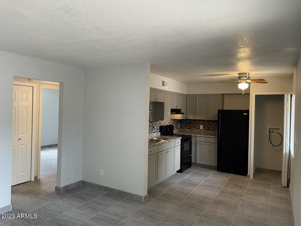 1222 East Mountain View Road, Unit 114 208 214 Phoenix, AZ 85020 - Photo 3 of 21 a kitchen with a refrigerator and a sink