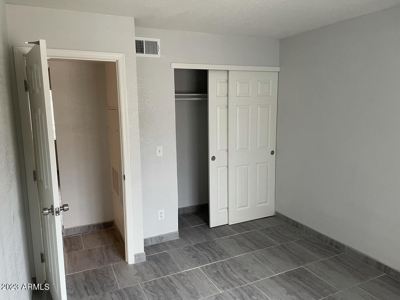 1222 East Mountain View Road, Unit 114 208 214 Phoenix, AZ 85020 - Photo 10 of 21 an empty room with closet and a bathroom