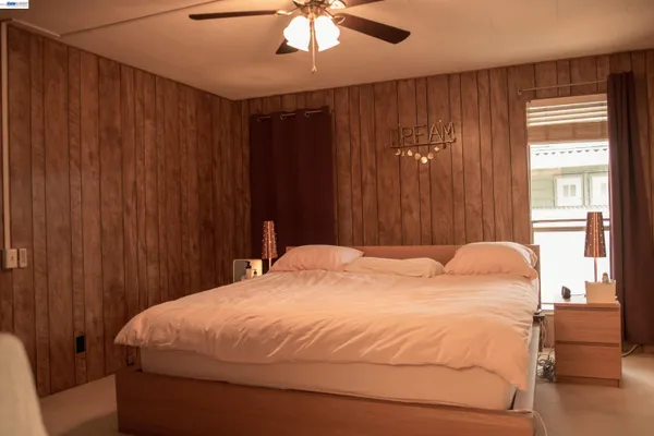 a bedroom with bed and chair