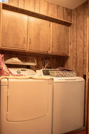 a view of walk in closet with clothes