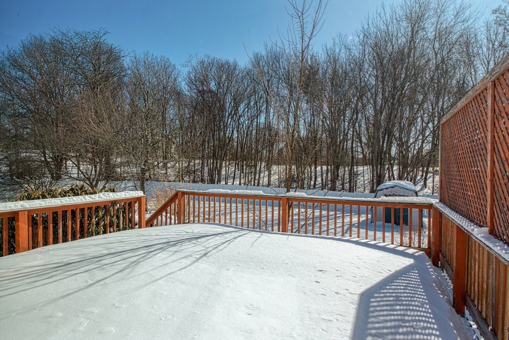 12 Brewster Road Randolph, MA 02368 - Photo 20 of 27 a view of a deck with a floor to ceiling window and trees