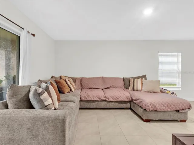 a bedroom with a bed couch and window