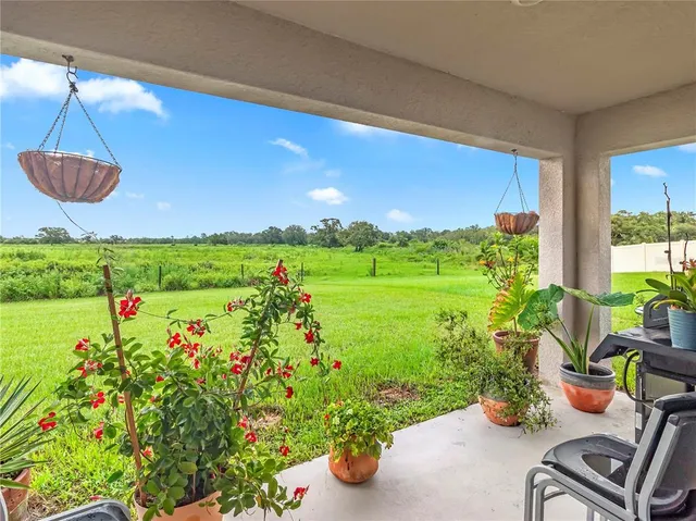 a view of a table and chairs in patio with potted plants