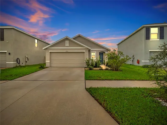 a front view of a house with a yard and garage