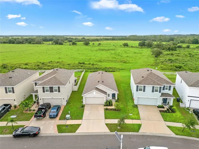 an aerial view of multiple houses with yard