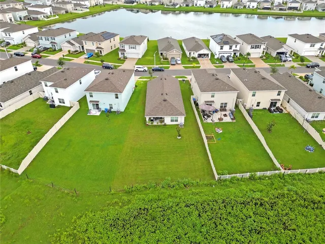 an aerial view of a house with a lake view