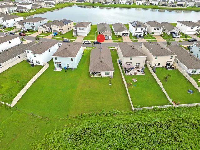 an aerial view of a house with a lake view