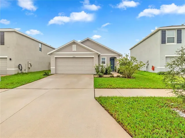 a front view of a house with a yard and garage