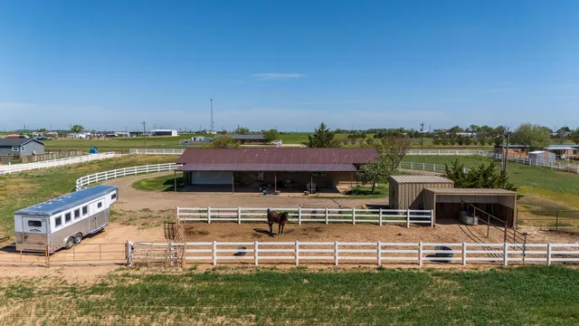 a view of a swimming pool with seating area and lake view