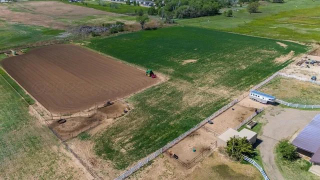 an aerial view of a house with a yard and lake view