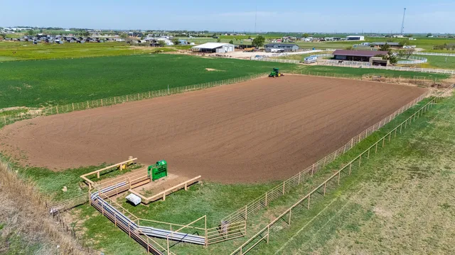 an aerial view of a house with a yard and lake view