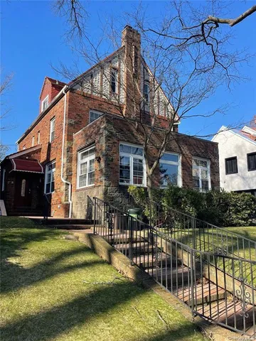 a view of a house with a yard from a lake view