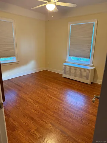 a view of room with wooden floor and window