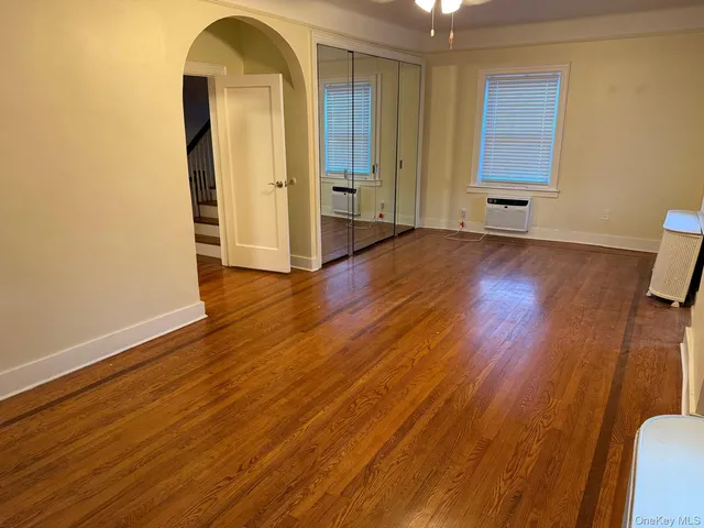 a view of a room with wooden floor and pool table