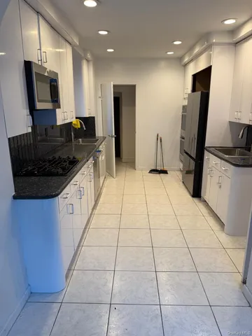 a kitchen with stainless steel appliances granite countertop a sink and a stove