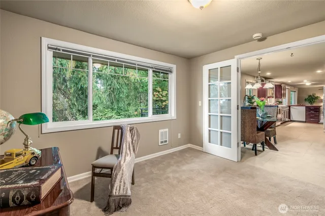 a view of a workspace with furniture and a window