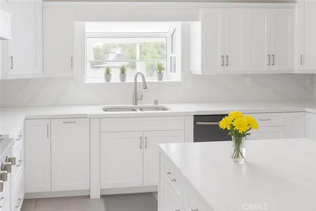 a bathroom with a sink a vanity and a window