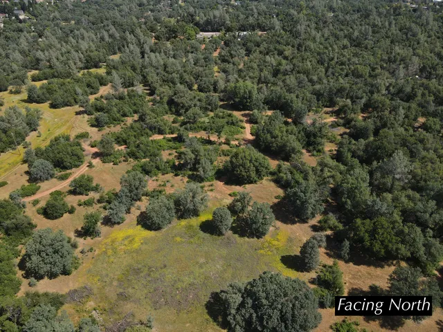 an aerial view of a houses with yard