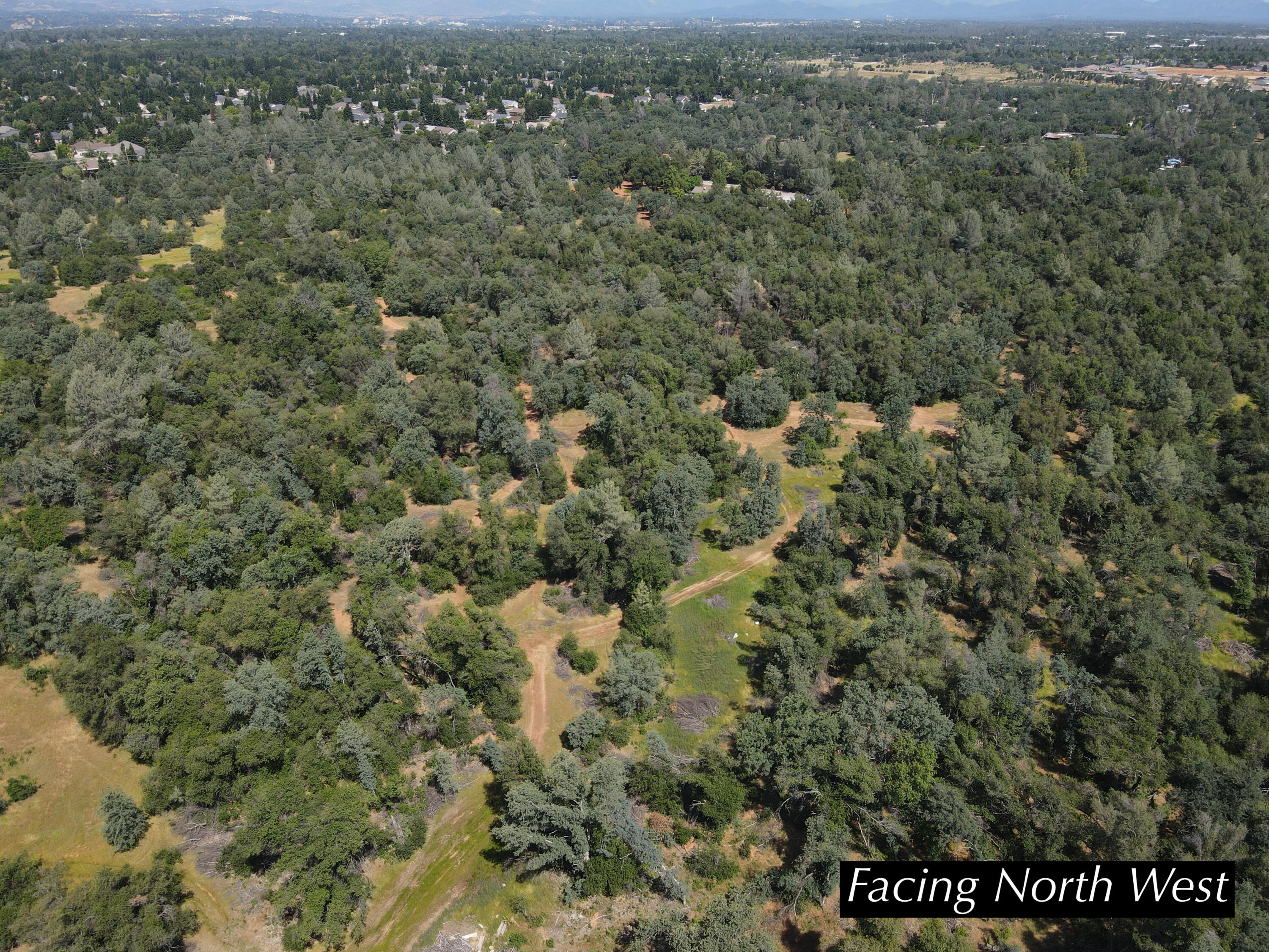 4655 Goodwater Avenue Redding, CA 96002 - Photo 9 of 13 a view of a city with lush green forest