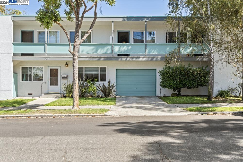 a house that has a tree in front of it