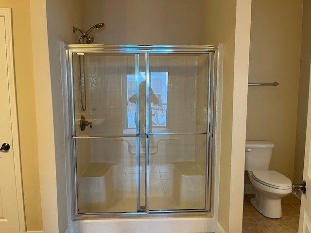 238 Abercorn Way Woodstock, GA 30188 - Photo 17 of 27 a bathroom with a glass shower door