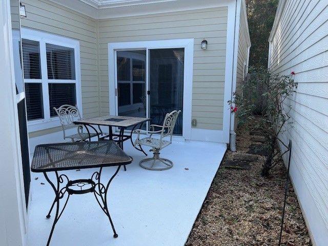 238 Abercorn Way Woodstock, GA 30188 - Photo 24 of 27 a view of a patio with table and chairs with wooden floor and plants