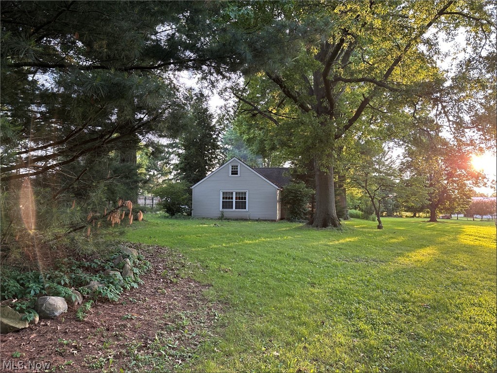10970 Durkee Road Grafton, OH 44044 - Photo 6 of 9 Expansive green lawn surrounds a light gray clapboard structure