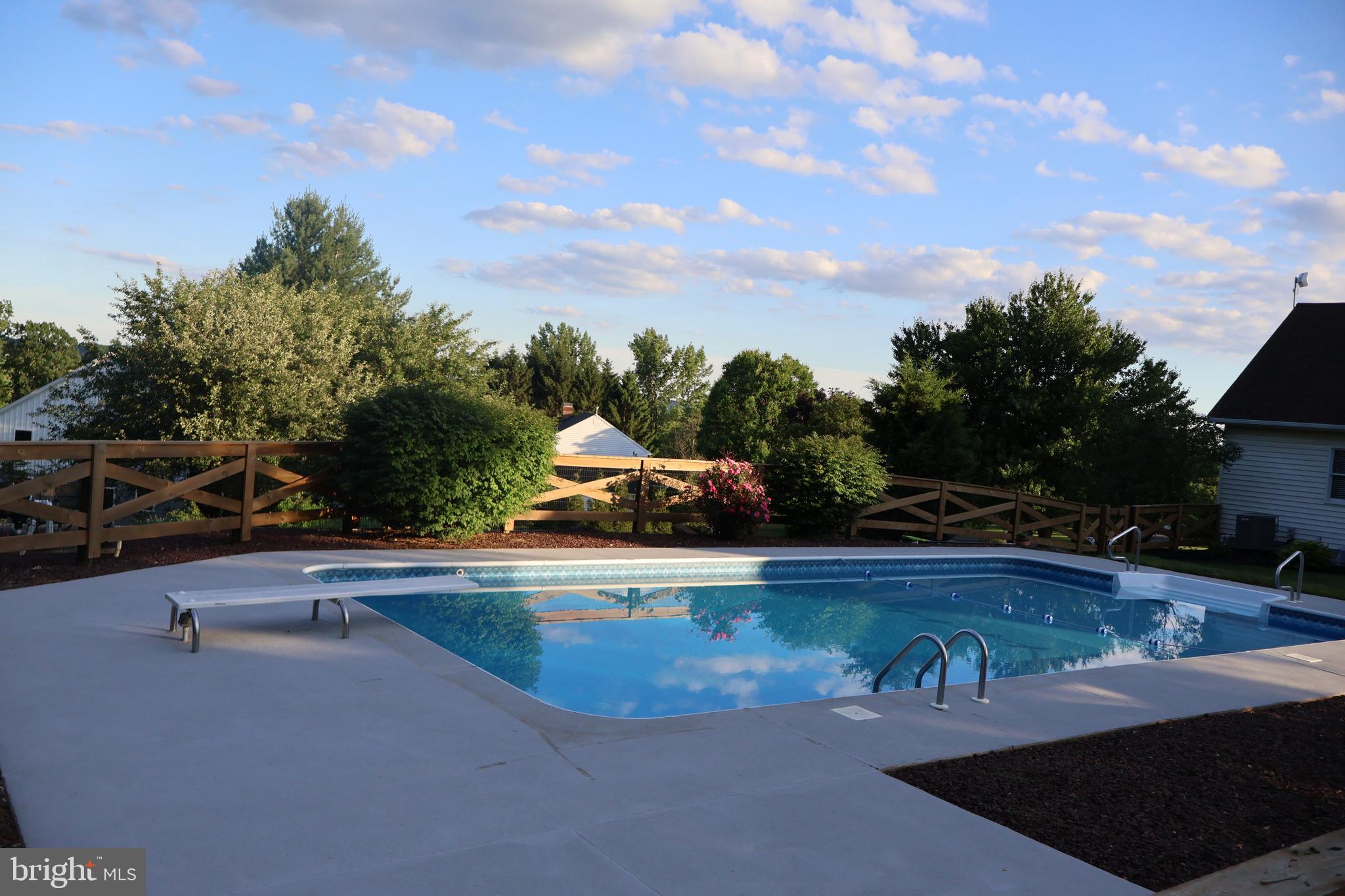 509 Buchland Road Narvon, PA 17555 - Photo 77 of 94 a view of a swimming pool with an outdoor seating and a garden