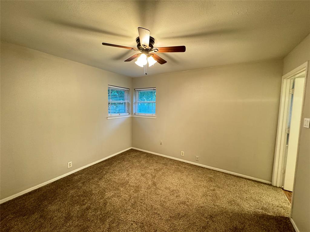 2004 Throckmorton Street Gainesville, TX 76240 - Photo 11 of 24 an empty room with windows and fan