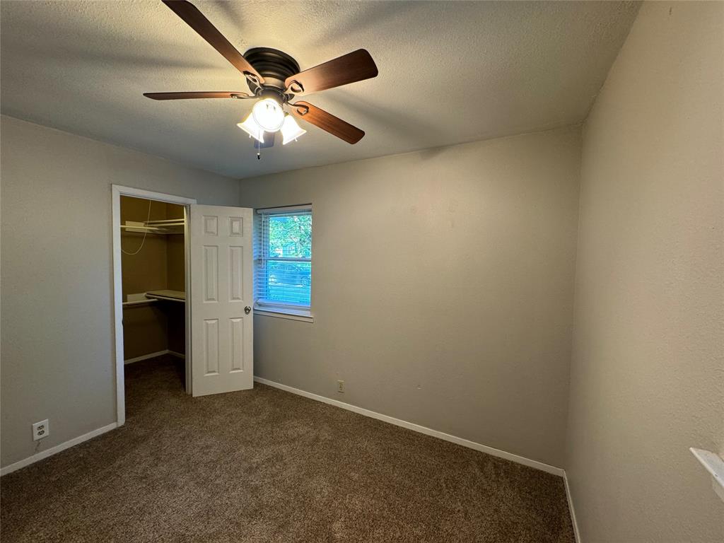 2004 Throckmorton Street Gainesville, TX 76240 - Photo 12 of 24 an empty room with closet and windows
