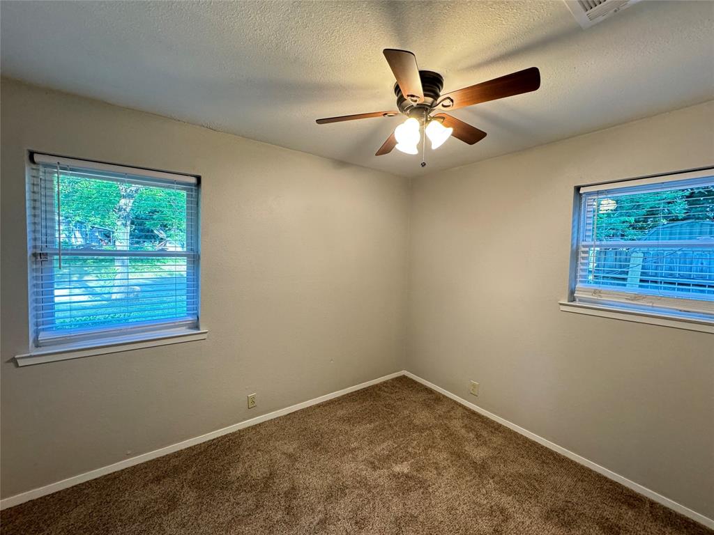 2004 Throckmorton Street Gainesville, TX 76240 - Photo 13 of 24 a view of an empty room with a window
