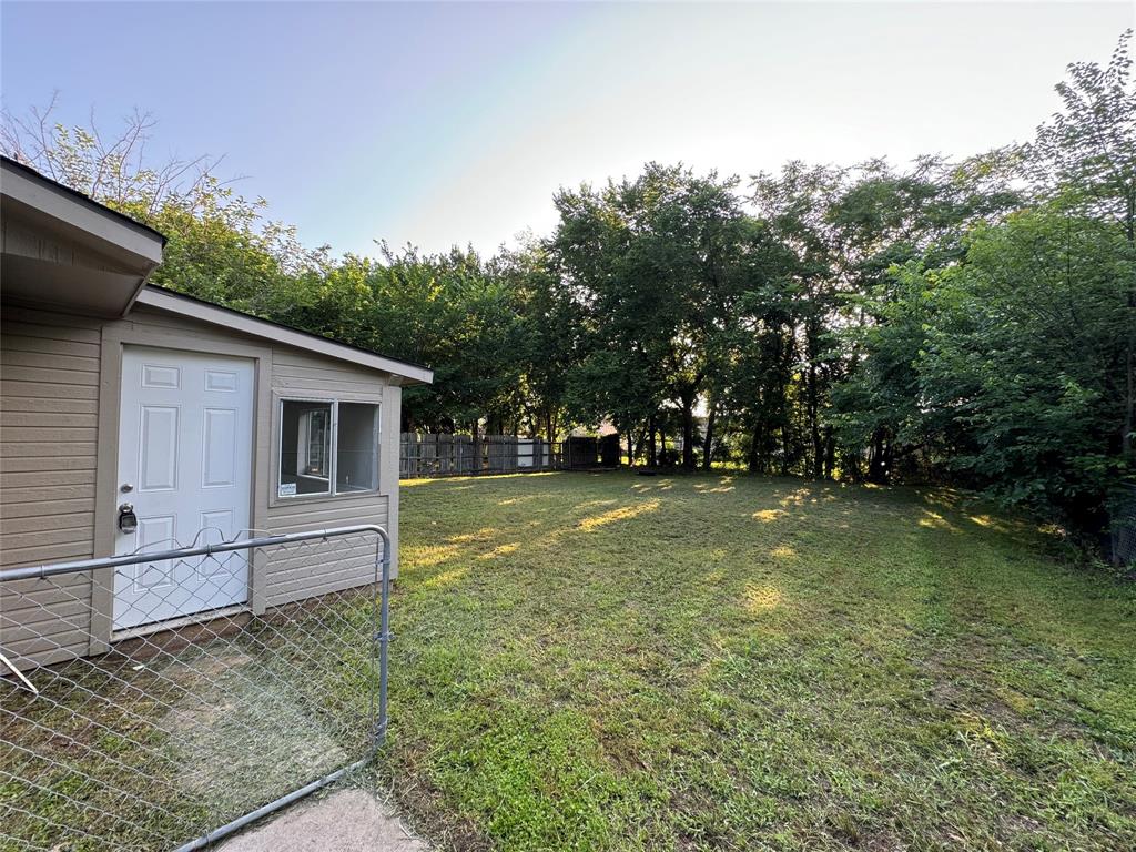 2004 Throckmorton Street Gainesville, TX 76240 - Photo 6 of 24 a view of backyard of house with trees
