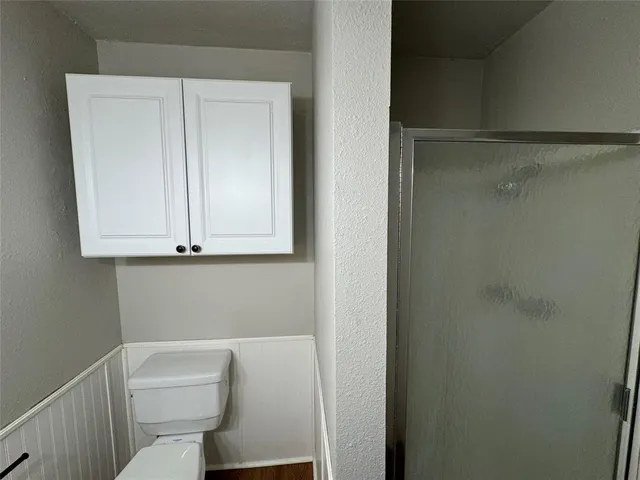 a white toilet sitting next to a bathroom sink