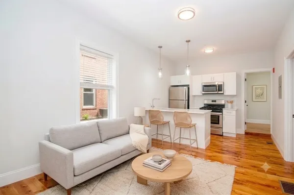a living room with furniture a dining table and kitchen view