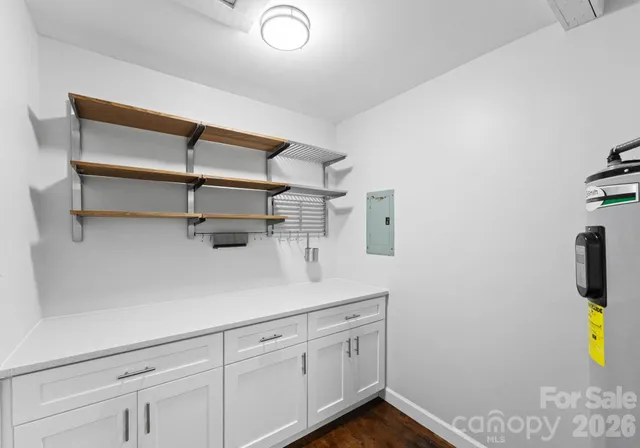 a kitchen with white cabinets and white appliances