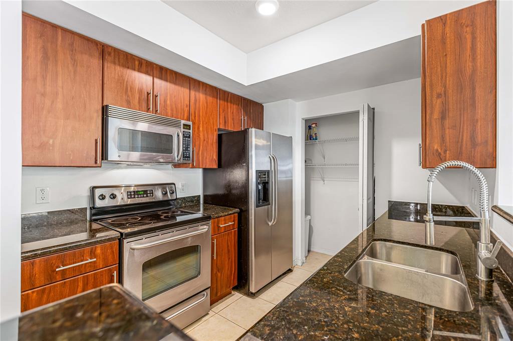 a kitchen with a sink cabinets and stainless steel appliances