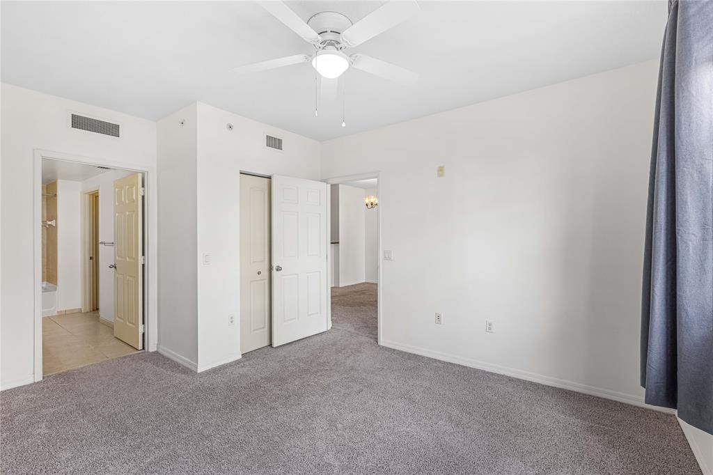 2421 Northeast 65th Street, Unit 318 Fort Lauderdale, FL 33308 - Photo 11 of 31 a view of an empty room with a ceiling fan