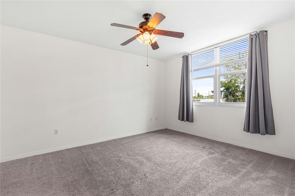 2421 Northeast 65th Street, Unit 318 Fort Lauderdale, FL 33308 - Photo 14 of 31 an empty room with a window