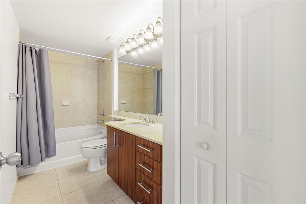 2421 Northeast 65th Street, Unit 318 Fort Lauderdale, FL 33308 - Photo 17 of 31 a bathroom with a granite countertop sink toilet and shower