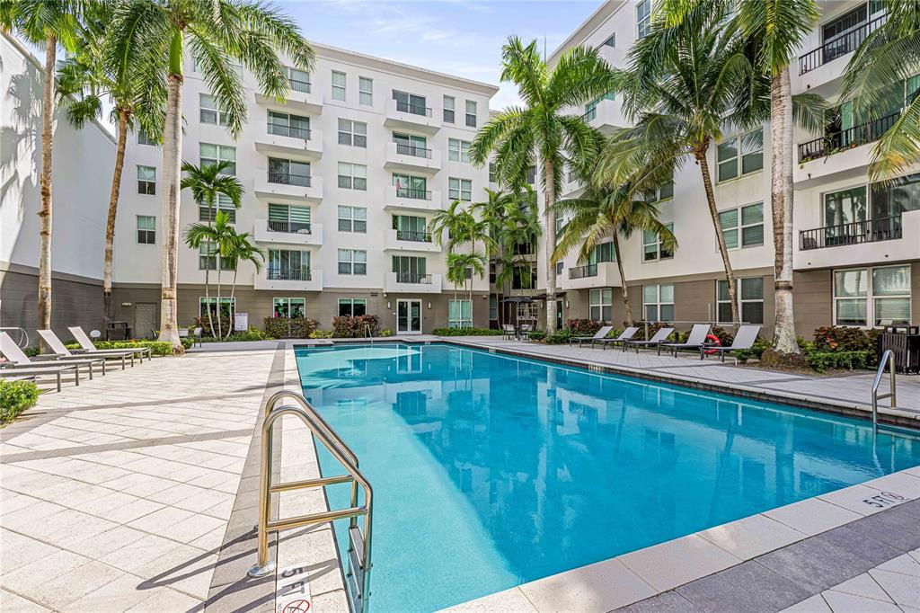 2421 Northeast 65th Street, Unit 318 Fort Lauderdale, FL 33308 - Photo 21 of 31 a swimming pool view with a outdoor seating
