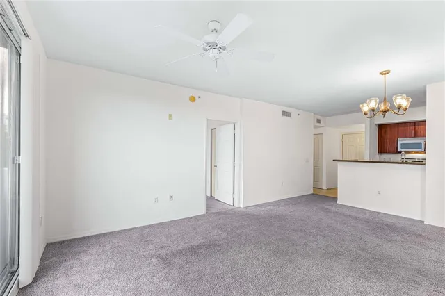 a view of a kitchen with a sink and a chandelier fan