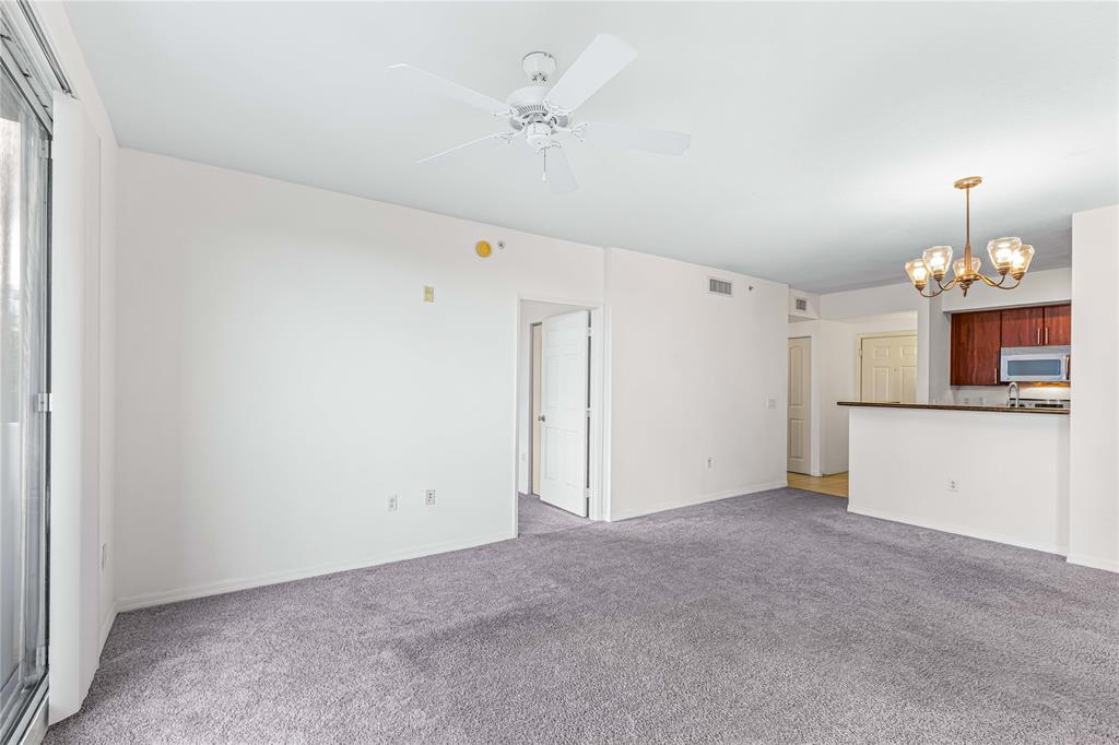 2421 Northeast 65th Street, Unit 318 Fort Lauderdale, FL 33308 - Photo 4 of 31 a view of a kitchen with a sink and a chandelier fan