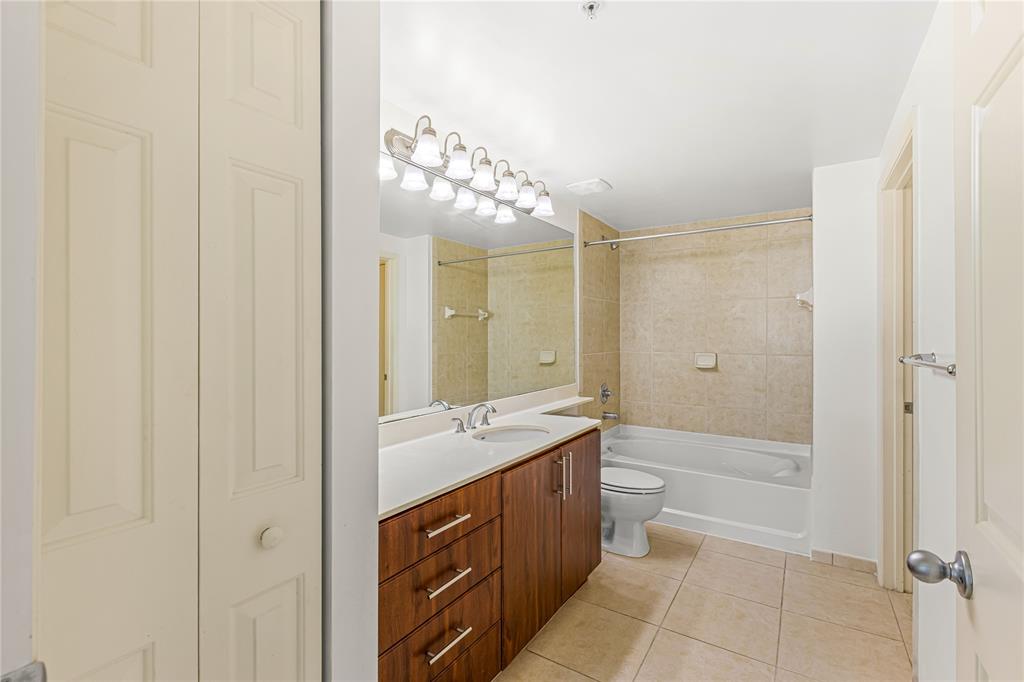 2421 Northeast 65th Street, Unit 318 Fort Lauderdale, FL 33308 - Photo 7 of 31 a spacious bathroom with a double vanity sink toilet mirror and bathtub