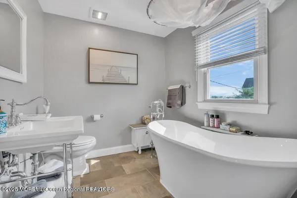 a bathroom with a double vanity sink toilet and shower