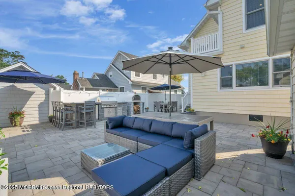 a view of a patio with chairs and potted plants