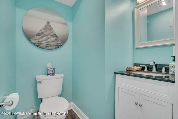 a bathroom with a toilet a sink and mirror