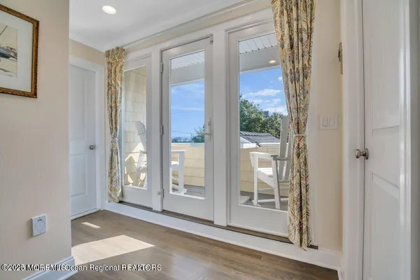 a dining hall with stainless steel appliances kitchen island granite countertop a dining table chairs and window