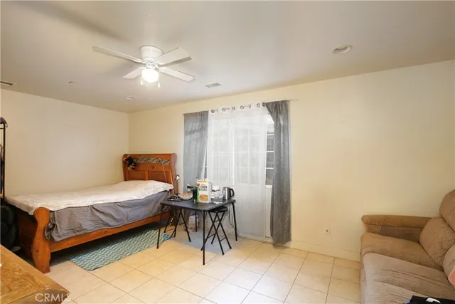 a bedroom with a bed and a couch