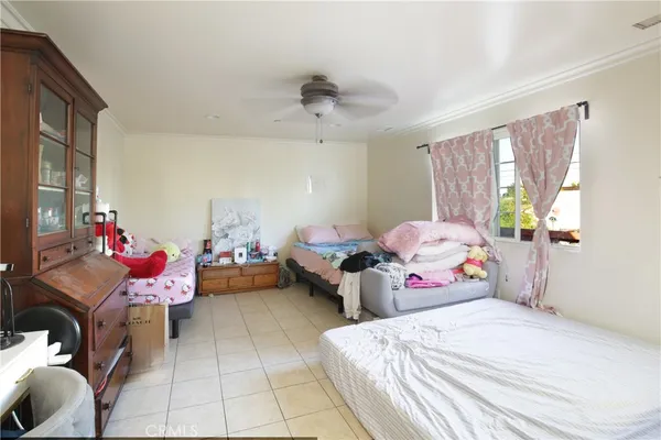 a bedroom with a bed and windows